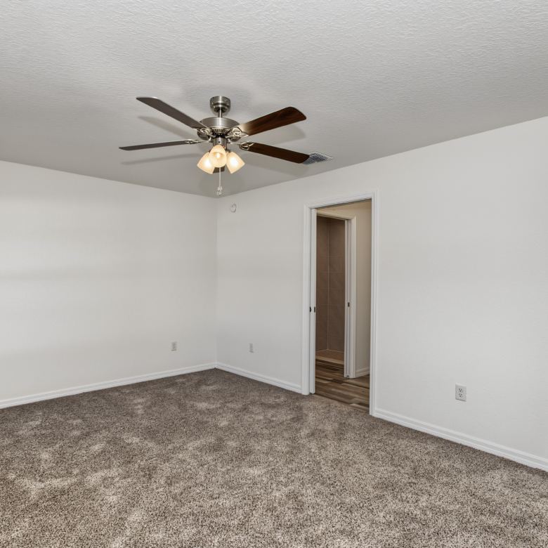 Bedroom interior looking toward bathroom and open walk-in closet