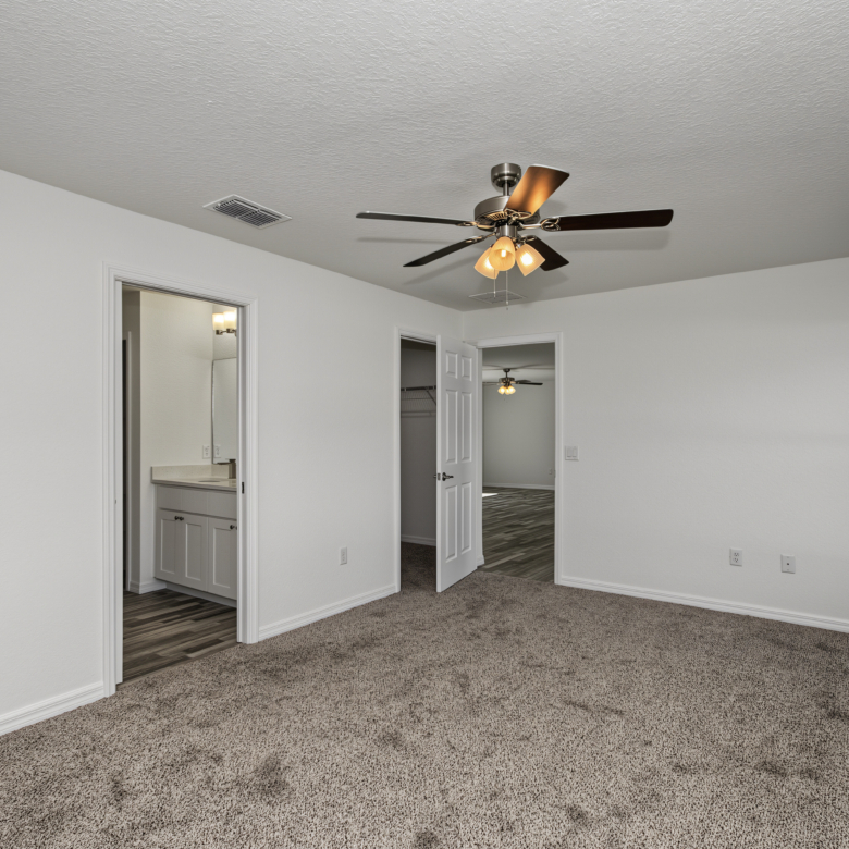 Bedroom view highlighting ensuite bathroom access and closet door